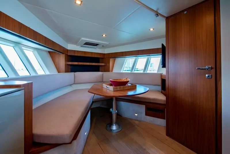 Amaretto Yacht Photos Pics Luxurious interior of 2015 Absolute 40 STL yacht with cozy seating and wooden finishes.