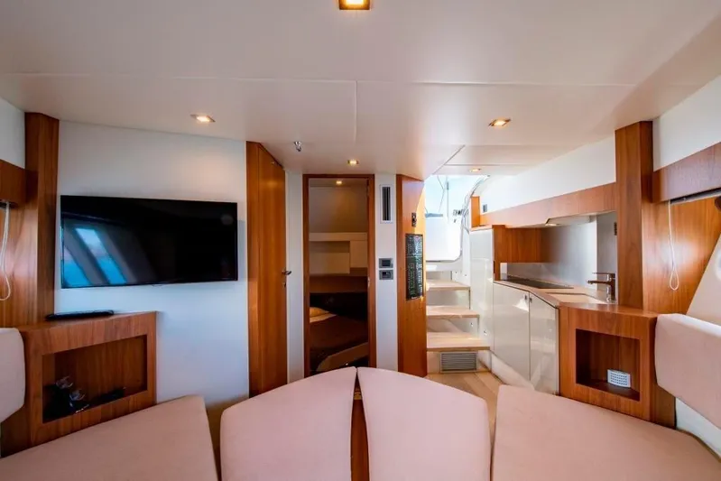 Amaretto Yacht Photos Pics Interior of 2015 Absolute 40 STL yacht with modern furnishings and a flat-screen TV.