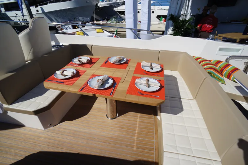 Amaretto Yacht Photos Pics Outdoor dining area on a 2015 Absolute 40 STL yacht, set for six.