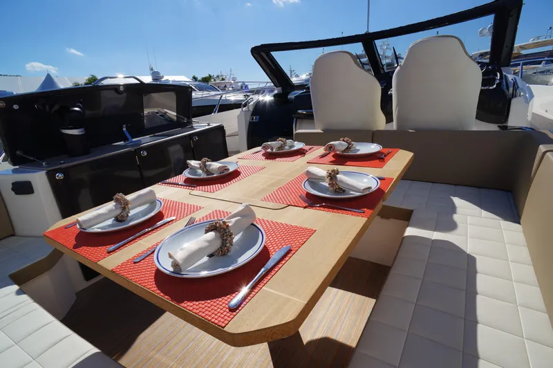 Amaretto Yacht Photos Pics Dining area on 2015 Absolute 40 STL yacht with table set for six.