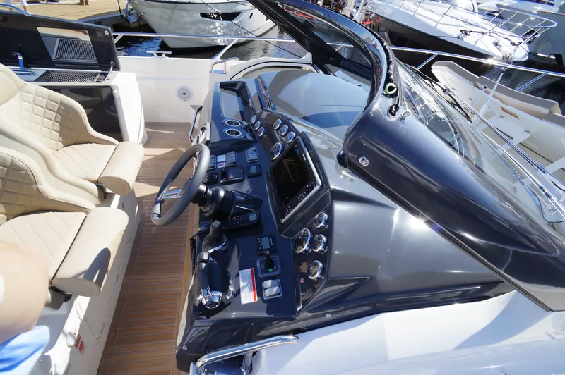 Amaretto Yacht Photos Pics Cockpit of a 2015 Absolute 40 STL yacht with modern controls and beige seating.