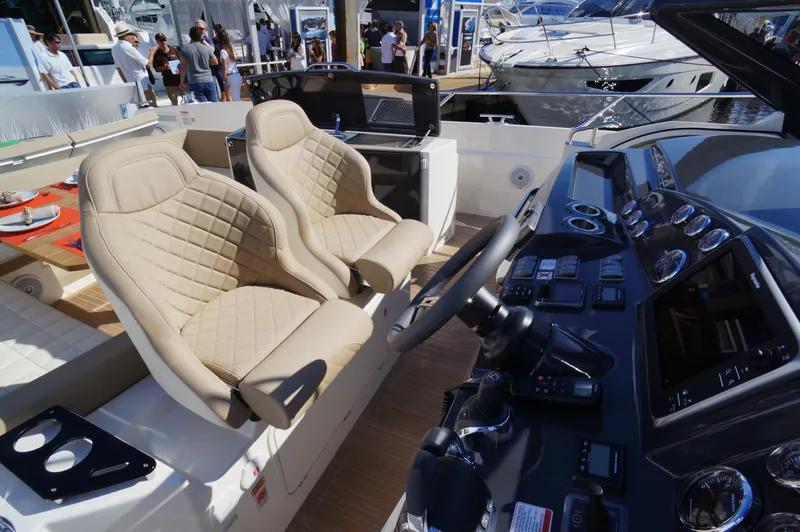 Amaretto Yacht Photos Pics Luxury cockpit of 2015 Absolute 40 STL yacht with beige leather seats.