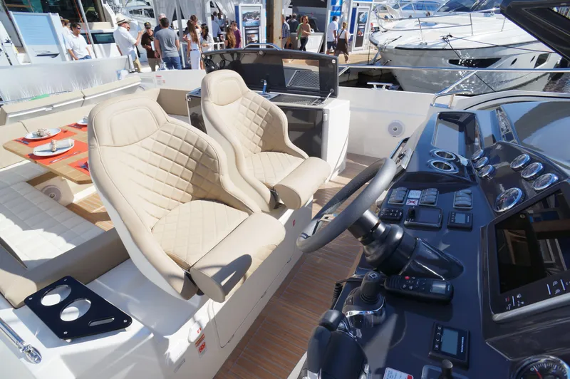 Amaretto Yacht Photos Pics Luxury interior of 2015 Absolute 40 STL yacht with beige seats and modern dashboard.