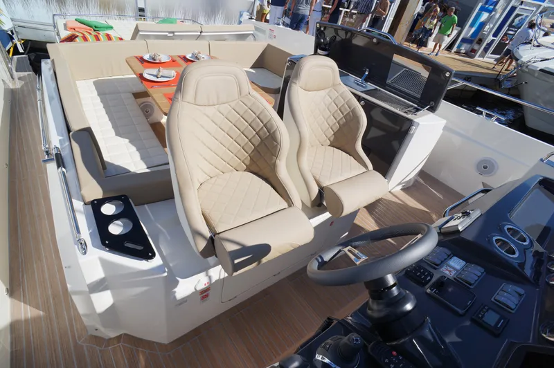 Amaretto Yacht Photos Pics Luxury interior of 2015 Absolute 40 STL yacht with beige seating and modern controls.