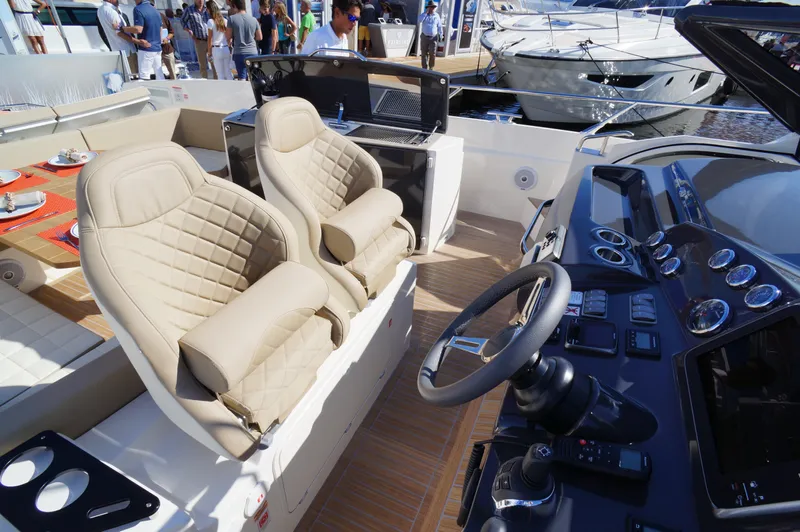 Amaretto Yacht Photos Pics Interior of a 2015 Absolute 40 STL yacht with luxurious seating and control panel.