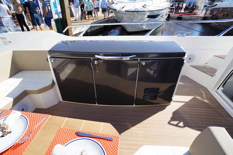 Amaretto Yacht Photos Pics Outdoor dining area on 2015 Absolute 40 STL yacht with docked boats in background.