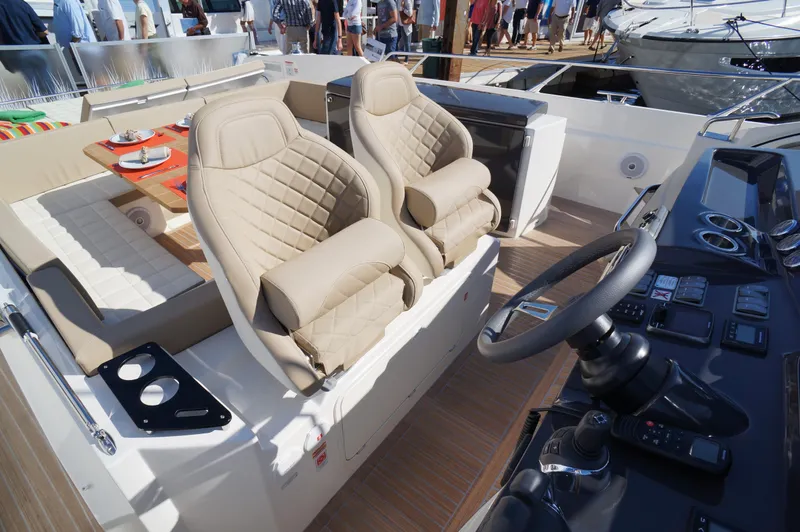 Amaretto Yacht Photos Pics Interior of 2015 Absolute 40 STL yacht with beige leather seats and modern dashboard.