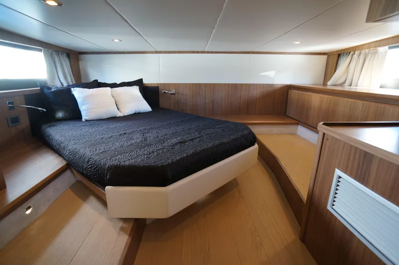 Amaretto Yacht Photos Pics Luxurious bedroom interior of 2015 Absolute 40 STL yacht with modern wood finish.