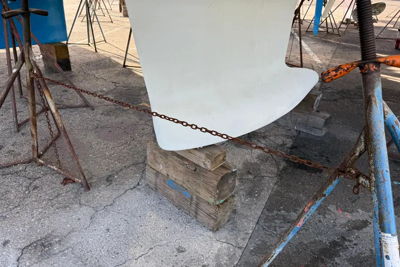  Yacht Photos Pics Keel of 2021 Beneteau Oceanis 35.1 sailboat supported by stands and chains.