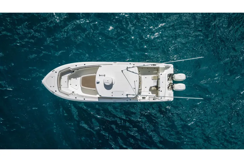 330 Boston Whaler Yacht Photos Pics Aerial view of 2017 Boston Whaler 330 Outrage boat on clear blue water.