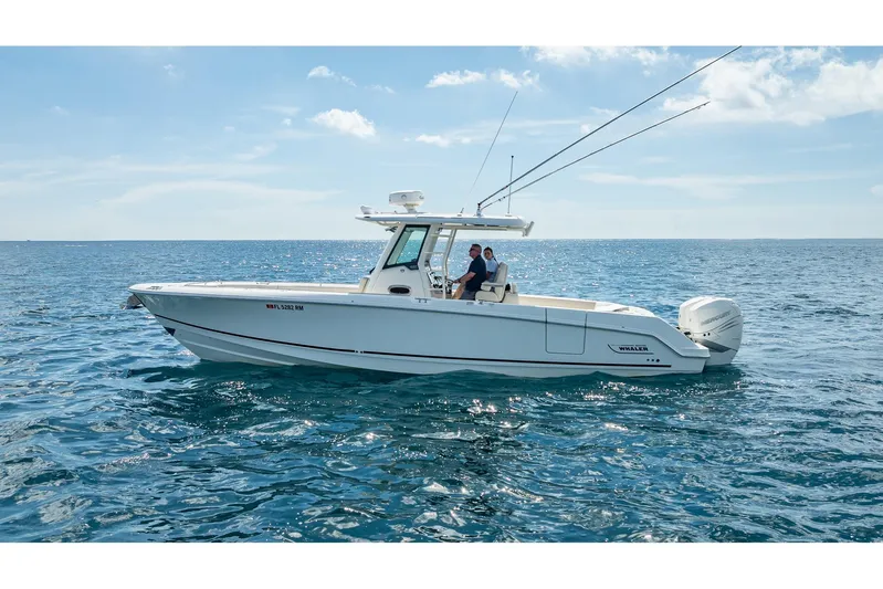 330 Boston Whaler Yacht Photos Pics 2017 Boston Whaler 330 Outrage boat cruising on open sea under clear sky.