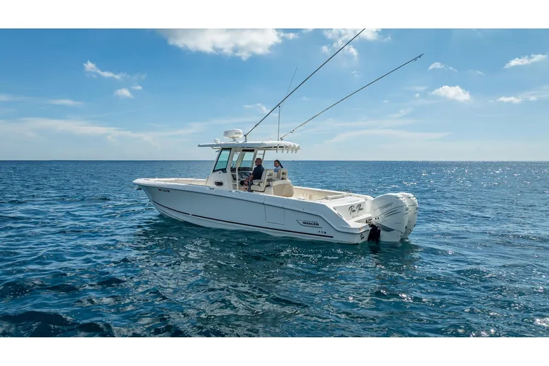 330 Boston Whaler Yacht Photos Pics 2017 Boston Whaler 330 Outrage boat cruising on open ocean under clear blue sky.