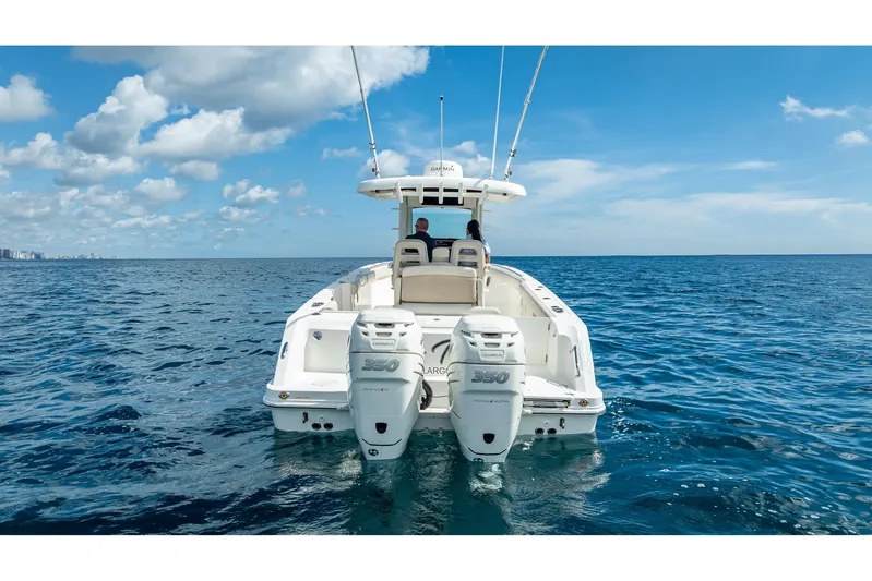330 Boston Whaler Yacht Photos Pics 2017 Boston Whaler 330 Outrage on open sea, featuring twin 350 engines, under clear blue sky.