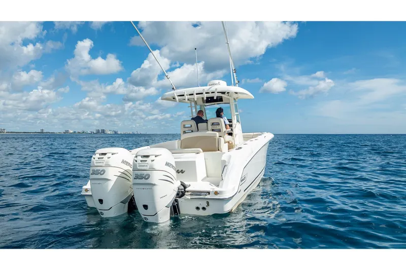 330 Boston Whaler Yacht Photos Pics 2017 Boston Whaler 330 Outrage boat on open sea with twin Mercury engines.