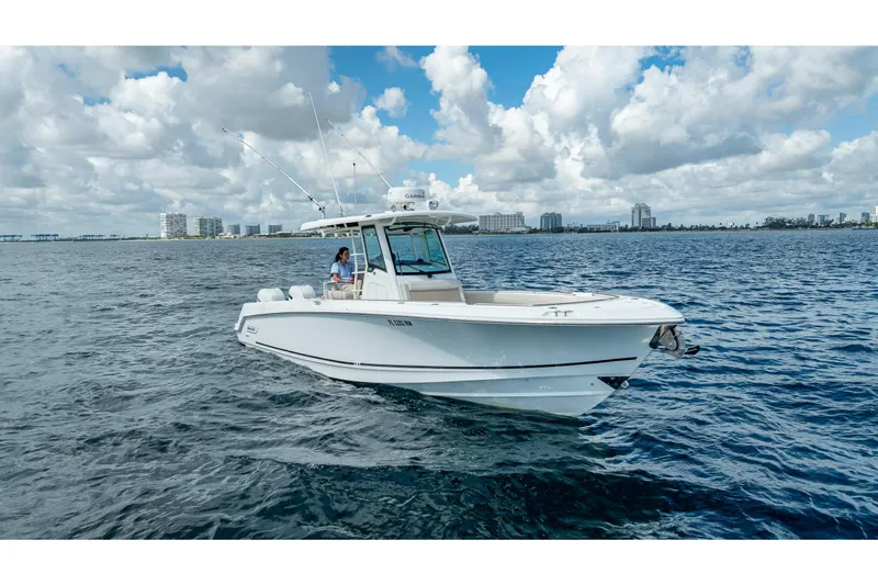 330 Boston Whaler Yacht Photos Pics 2017 Boston Whaler 330 Outrage boat cruising on open water under cloudy sky.