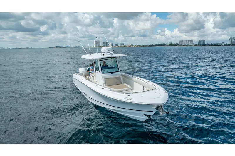 330 Boston Whaler Yacht Photos Pics 2017 Boston Whaler 330 Outrage boat cruising on open water under cloudy skies.