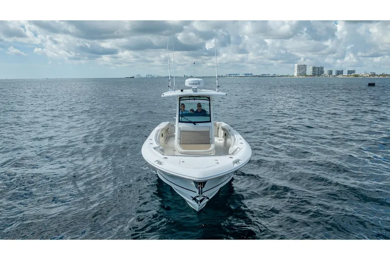 330 Boston Whaler Yacht Photos Pics 2017 Boston Whaler 330 Outrage boat on open water under cloudy sky.