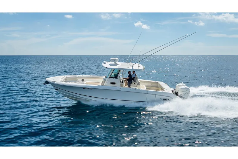 330 Boston Whaler Yacht Photos Pics 2017 Boston Whaler 330 Outrage cruising on open ocean under clear skies.