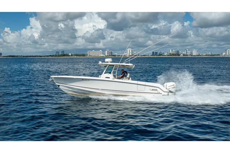 330 Boston Whaler Yacht Photos Pics 2017 Boston Whaler 330 Outrage cruising on open water with city skyline in background.