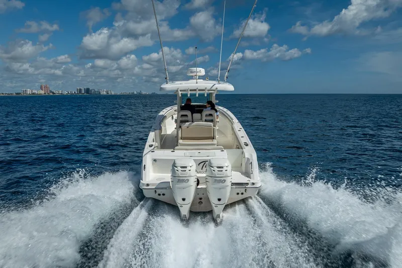 330 Boston Whaler Yacht Photos Pics 2017 Boston Whaler 330 Outrage cruising on open ocean with city skyline in background.