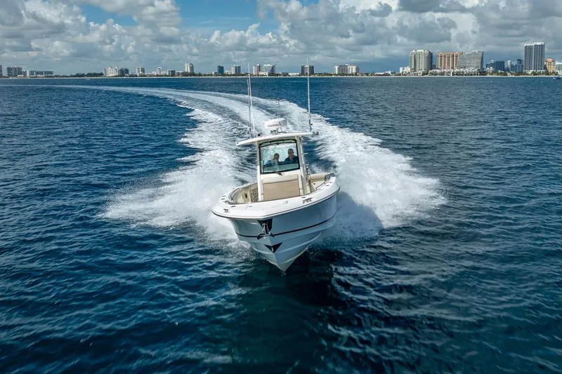 330 Boston Whaler Yacht Photos Pics 2017 Boston Whaler 330 Outrage cruising on open water with city skyline in background.