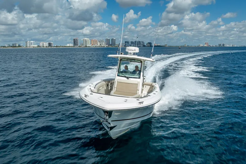330 Boston Whaler Yacht Photos Pics 2017 Boston Whaler 330 Outrage cruising on open water with city skyline in background.