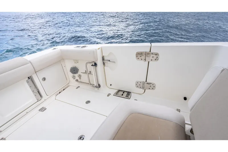 330 Boston Whaler Yacht Photos Pics 2017 Boston Whaler 330 Outrage boat interior with ocean view, featuring seating and storage.