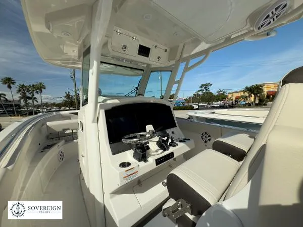 312-027 Yacht Photos Pics 2024 Sailfish 312 boat interior with modern helm, steering wheel, and seating.
