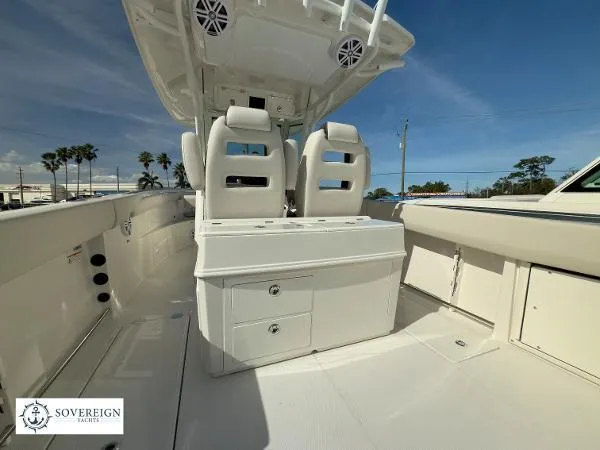 312-027 Yacht Photos Pics 2024 Sailfish 312 boat interior with dual seats and storage, under clear blue sky.