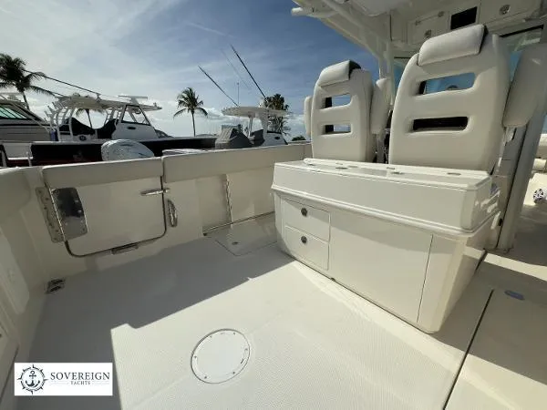 312-027 Yacht Photos Pics 2024 Sailfish 312 boat interior with seating and storage, docked under clear skies.