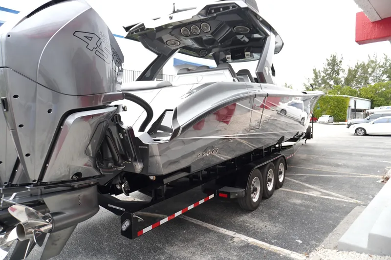 C Daze Yacht Photos Pics 2024 Adrenaline 47 Reaper boat on trailer, sleek design, parked in lot.