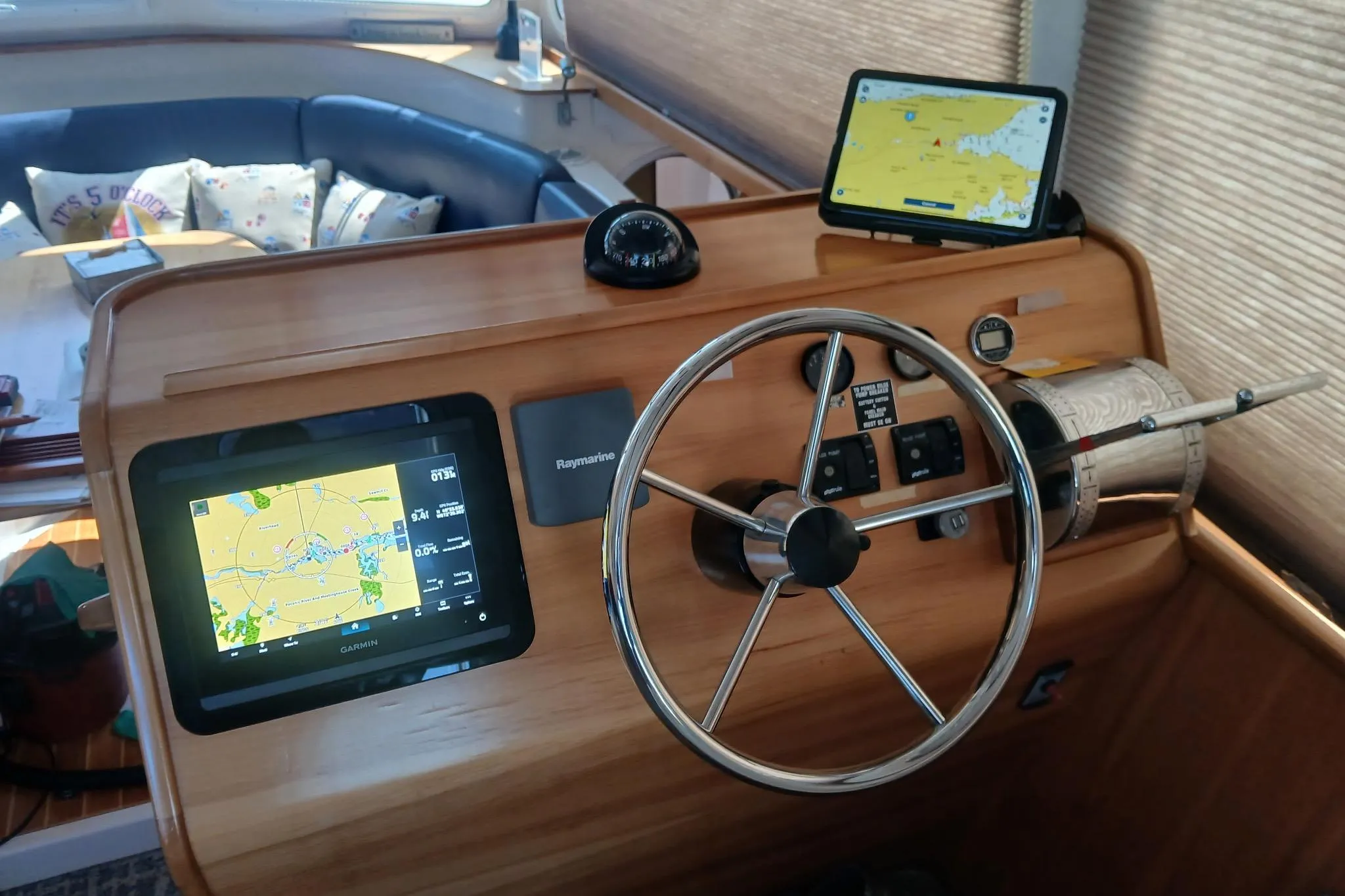 Steering console of 2006 PDQ PowerCat with navigation screens and controls.