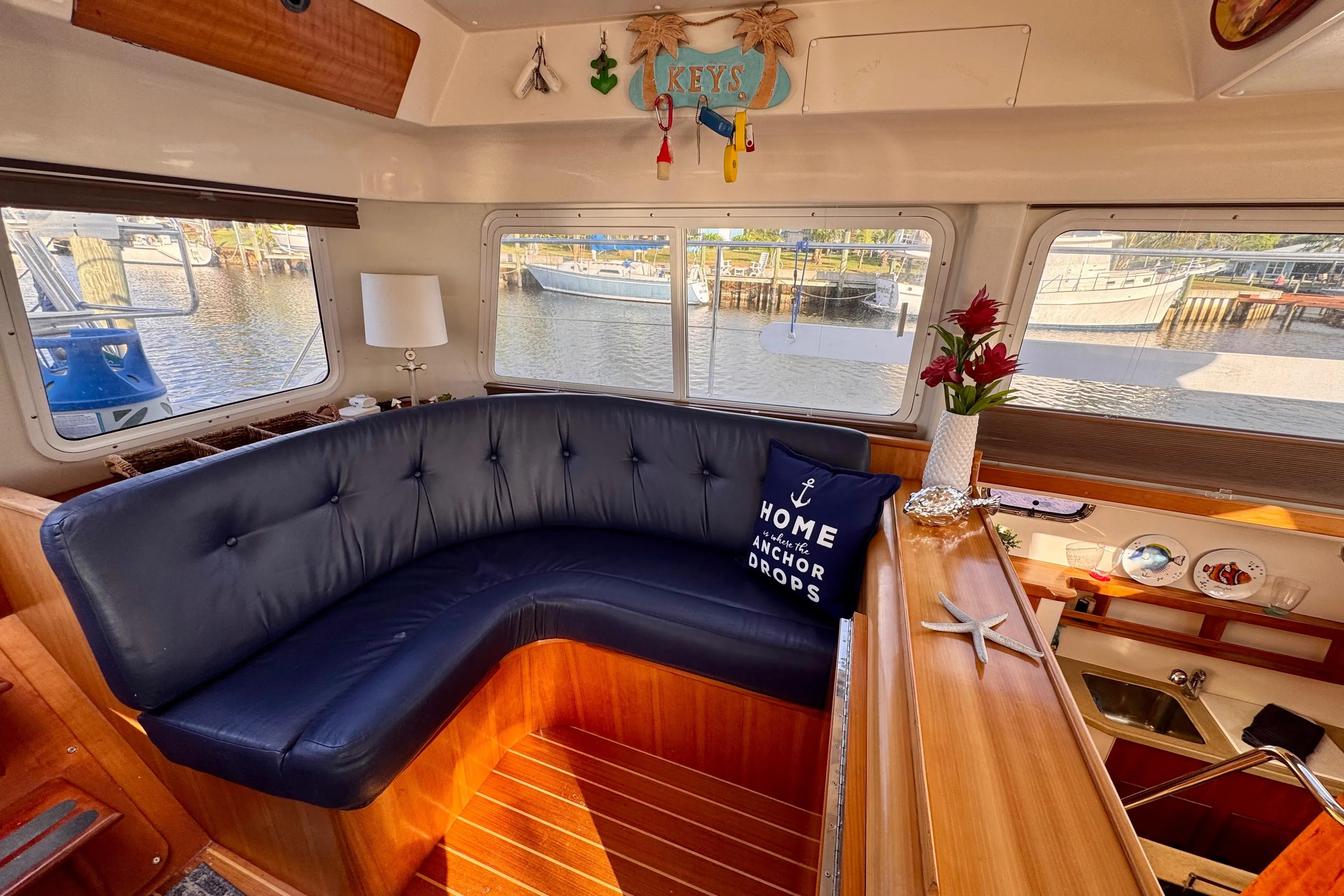 Interior of a 2006 PDQ PowerCat boat with cozy seating and nautical decor.