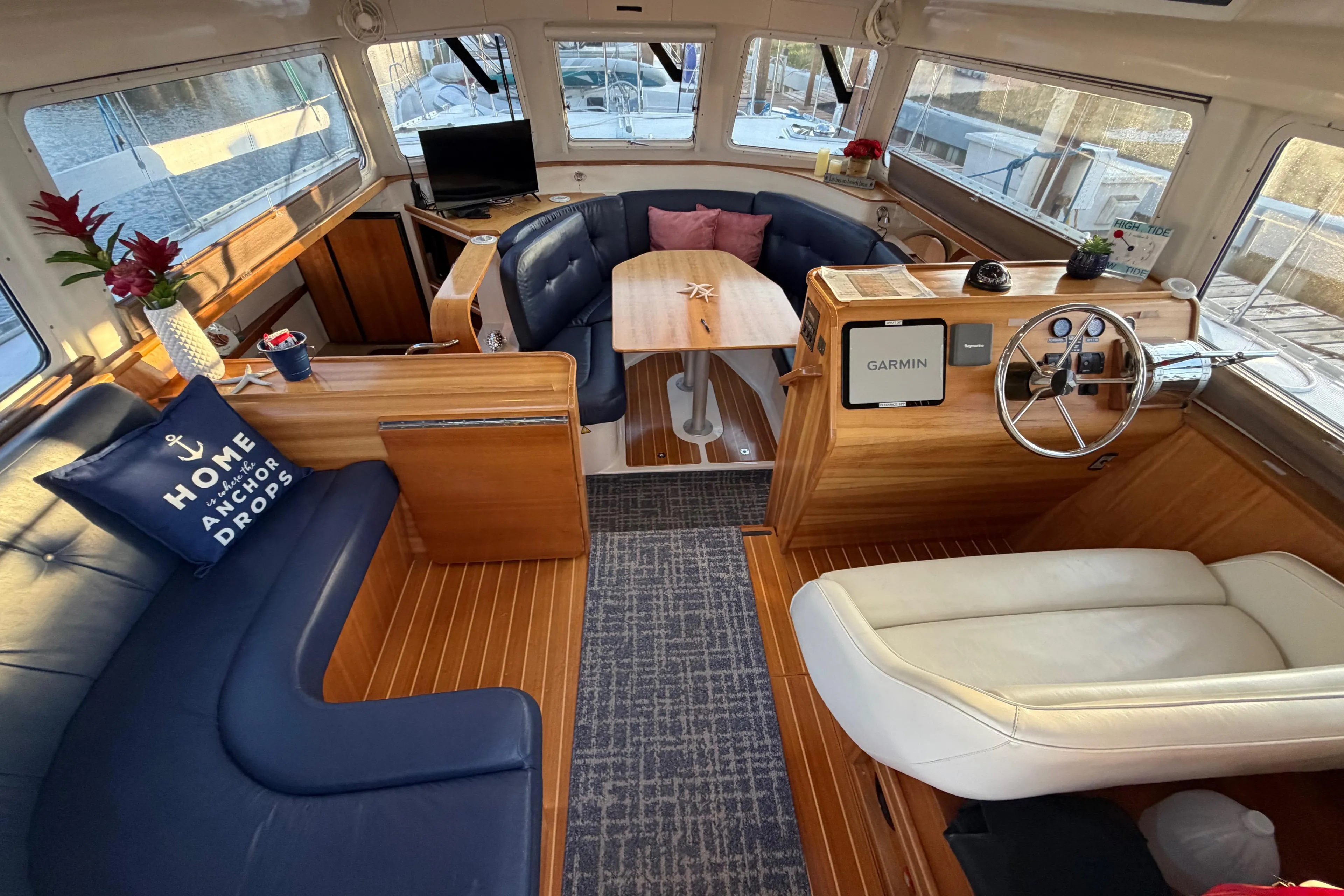 Interior of 2006 PDQ PowerCat boat with cozy seating and wooden accents.