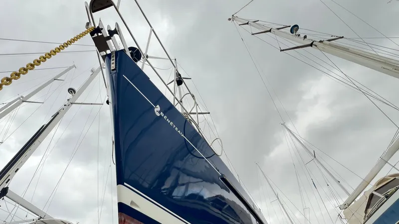 1730 Yacht Photos Pics 1999 Beneteau Oceanis Clipper 44 CC sailboat with blue hull, docked under cloudy skies.