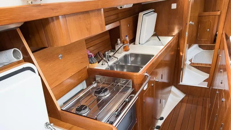 1730 Yacht Photos Pics Galley kitchen in 1999 Beneteau Oceanis Clipper 44 CC yacht with wood finish.