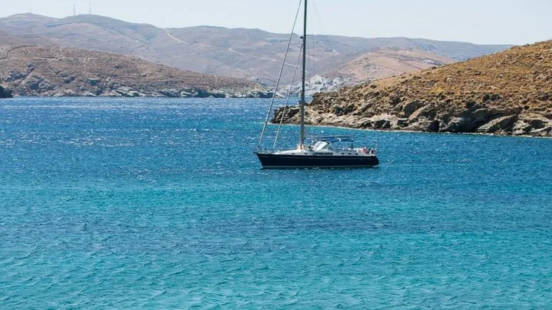 1730 Yacht Photos Pics Sailboat Beneteau Oceanis Clipper 44 CC, 1999, anchored in clear blue waters near rocky coastline.