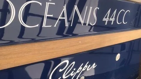 1730 Yacht Photos Pics 1999 Beneteau Oceanis Clipper 44 CC yacht nameplate with elegant lettering.