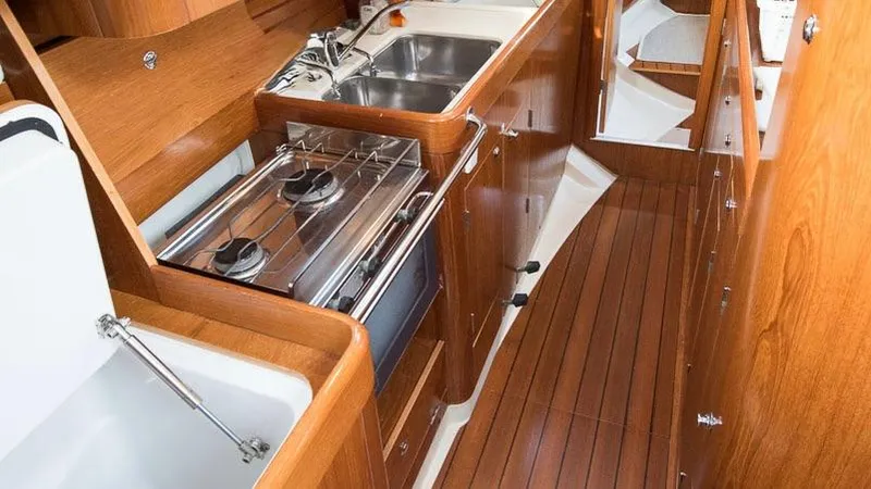 1730 Yacht Photos Pics Interior of 1999 Beneteau Oceanis Clipper 44 CC yacht kitchen with wood finish.