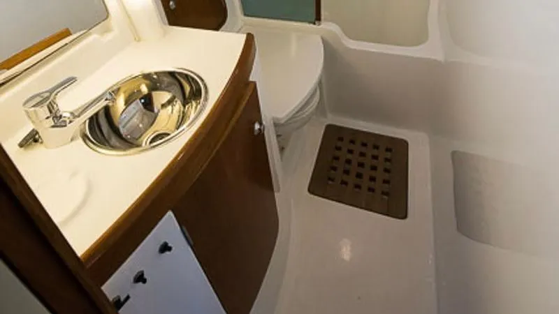 1730 Yacht Photos Pics Bathroom interior of 1999 Beneteau Oceanis Clipper 44 CC yacht, featuring sink and toilet.
