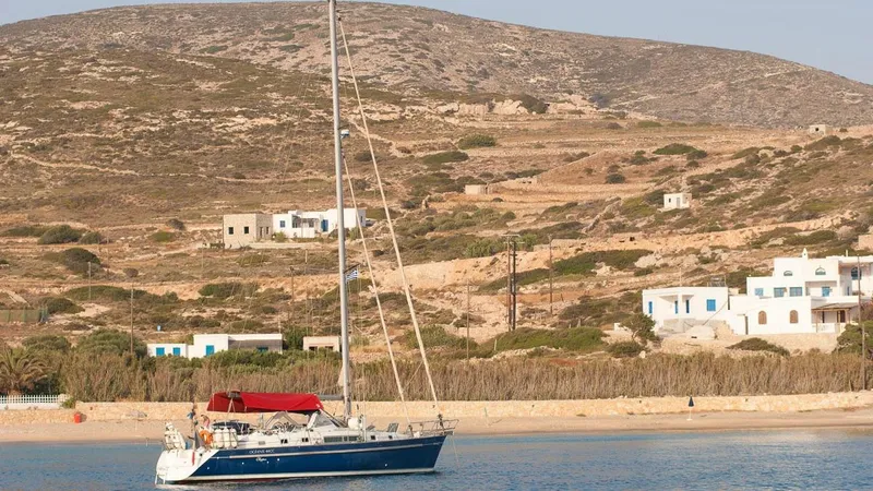 1730 Yacht Photos Pics Sailboat Beneteau Oceanis Clipper 44 CC, 1999, anchored near a scenic coastal village.