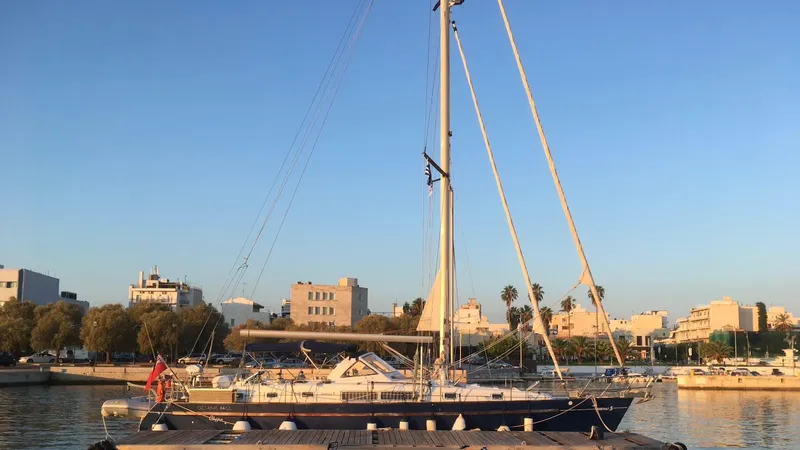 1730 Yacht Photos Pics 1999 Beneteau Oceanis Clipper 44 CC sailboat docked in a sunny marina.