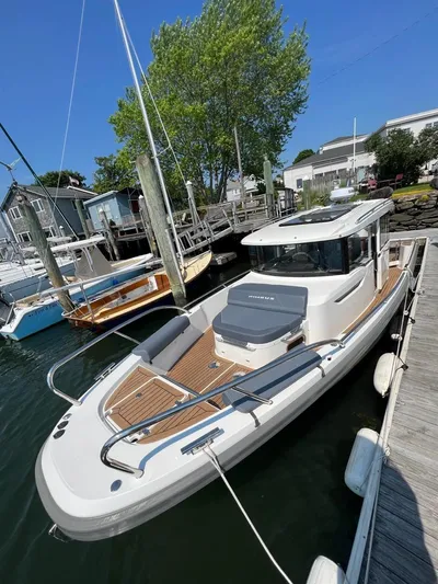 Crosswinds Yacht Photos Pics 2023 Nimbus C9 boat docked at a marina on a sunny day.