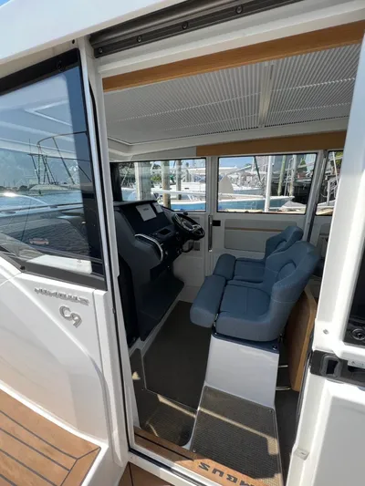 Crosswinds Yacht Photos Pics Interior of 2023 Nimbus C9 boat with modern cockpit and blue seating.