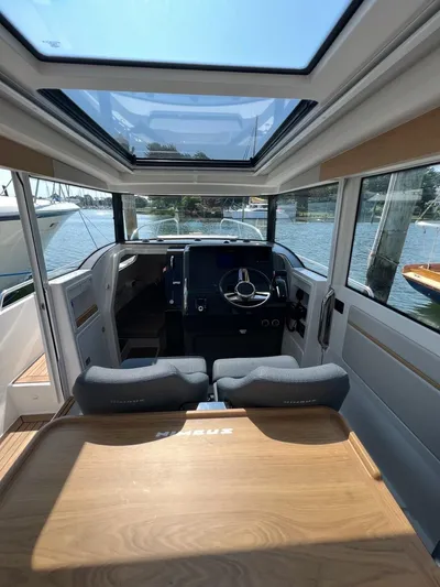 Crosswinds Yacht Photos Pics Interior of 2023 Nimbus C9 boat with modern helm and panoramic windows.