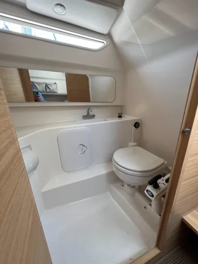 Crosswinds Yacht Photos Pics Modern bathroom in 2023 Nimbus C9 boat with toilet, sink, and mirror.