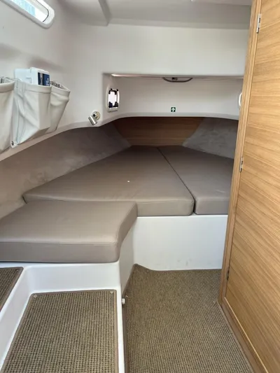 Crosswinds Yacht Photos Pics Interior cabin of 2023 Nimbus C9 boat with beige cushions and wooden accents.