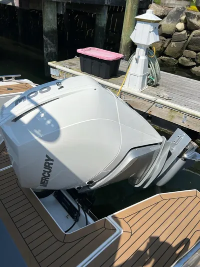 Crosswinds Yacht Photos Pics 2023 Nimbus C9 boat with a Mercury outboard motor docked at a marina.