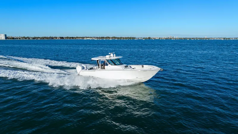  Yacht Photos Pics Bertram 39 CC 2023 boat cruising on open sea under clear sky.