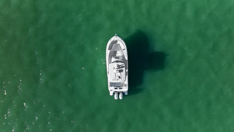  Yacht Photos Pics Aerial view of a 2023 Bertram 39 CC boat on green water.
